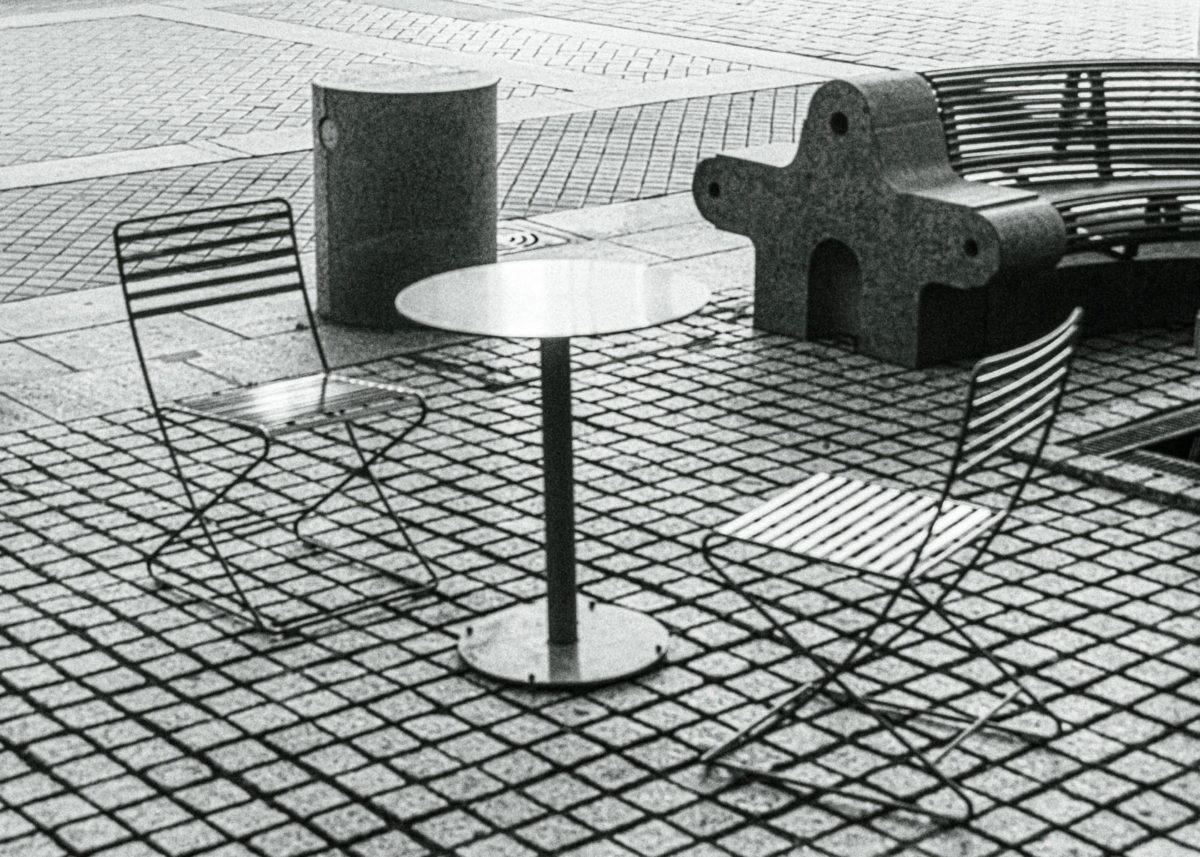 Patio Chairs and Table with Park Bench on Pavestone Walkway